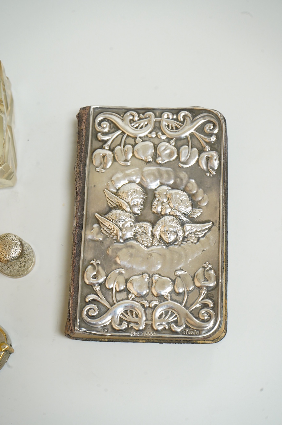 A small group of silver and other items, including an Edwardian silver mounted Common Prayer book(a.f.), a silver mounted matches holder, a silver mounted glass inkwell, a silver and mother of pearl fruit knife, two thim